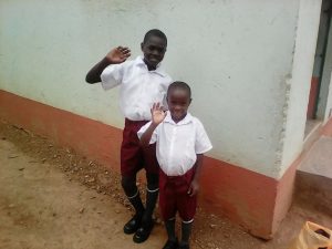 The 2 boys mentioned above happy and dressed in their new school uniforms